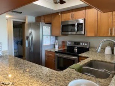 Discover this stunning 2-bedroom, 2-bath 1st-floor corner end on Hideaway Country Club in Florida - for sale on GolfHomes.com, golf home, golf lot