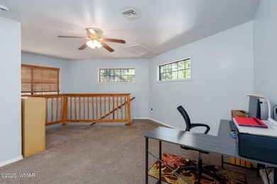 Tucked among towering pines, this inviting cabin offers the calm on Torreon Golf Club in Arizona - for sale on GolfHomes.com, golf home, golf lot