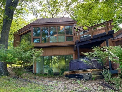 Tucked among mature trees, this unique beautifully updated on Seasons Ridge At Four Seasons in Missouri - for sale on GolfHomes.com, golf home, golf lot