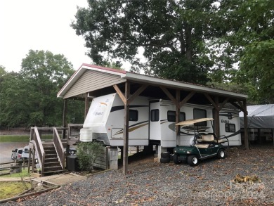 This 2008 31' Jayco RV w/ a custom-built covered structure on The Tillery Tradition Country Club in North Carolina - for sale on GolfHomes.com, golf home, golf lot