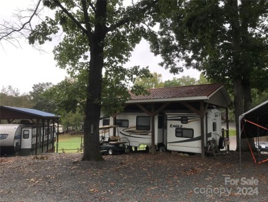 This 2008 31' Jayco RV w/ a custom-built covered structure on The Tillery Tradition Country Club in North Carolina - for sale on GolfHomes.com, golf home, golf lot