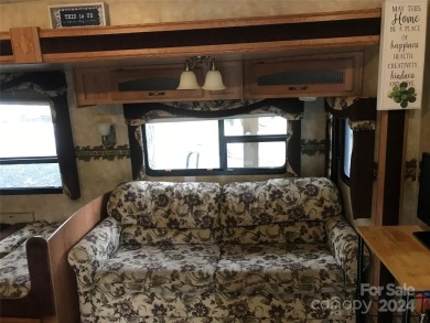 This 2008 31' Jayco RV w/ a custom-built covered structure on The Tillery Tradition Country Club in North Carolina - for sale on GolfHomes.com, golf home, golf lot