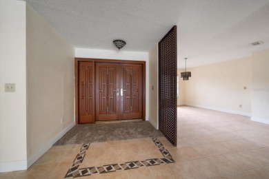 Welcome to this large ranch style, 4-bedroom, 2.5-bathroom home on Feather Sound Country Club in Florida - for sale on GolfHomes.com, golf home, golf lot