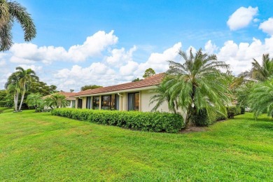 Nestled within lush landscaping and peaceful water views, this on Quail Ridge Golf Course and Country Club in Florida - for sale on GolfHomes.com, golf home, golf lot