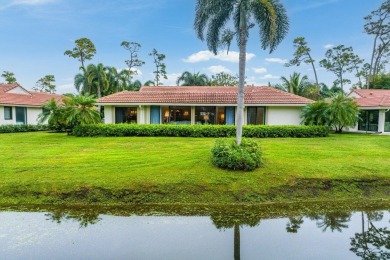 Nestled within lush landscaping and peaceful water views, this on Quail Ridge Golf Course and Country Club in Florida - for sale on GolfHomes.com, golf home, golf lot