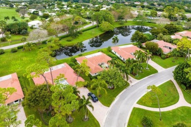 Nestled within lush landscaping and peaceful water views, this on Quail Ridge Golf Course and Country Club in Florida - for sale on GolfHomes.com, golf home, golf lot