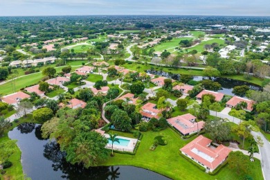 Nestled within lush landscaping and peaceful water views, this on Quail Ridge Golf Course and Country Club in Florida - for sale on GolfHomes.com, golf home, golf lot