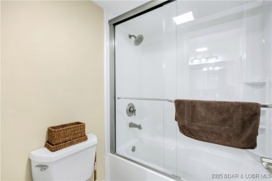 This charming 2,397 sq ft lakefront home in Tan-Tar-A Estates on The Oaks Golf Course in Missouri - for sale on GolfHomes.com, golf home, golf lot