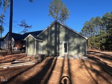 Welcome home to this charming three-bedroom, two-bath ranch on River Golf and Country Club at Lake Royale in North Carolina - for sale on GolfHomes.com, golf home, golf lot