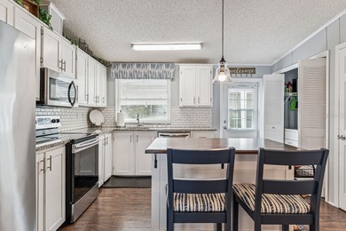 Welcome home to this beautifully updated 2-bedroom, 2-bath on Lake Henry Golf Club in Florida - for sale on GolfHomes.com, golf home, golf lot