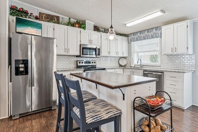 Welcome home to this beautifully updated 2-bedroom, 2-bath on Lake Henry Golf Club in Florida - for sale on GolfHomes.com, golf home, golf lot