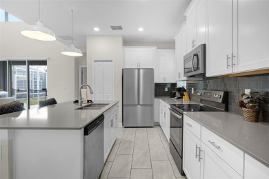 Step into resort-style living at 661 Drop Shot Drive, a on The Oasis Club at Champions Gate in Florida - for sale on GolfHomes.com, golf home, golf lot
