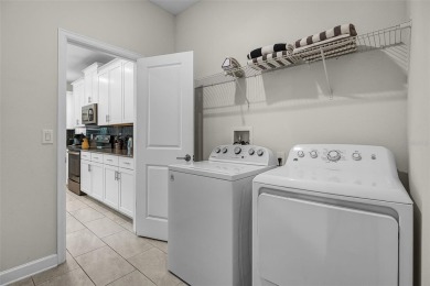 Step into resort-style living at 661 Drop Shot Drive, a on The Oasis Club at Champions Gate in Florida - for sale on GolfHomes.com, golf home, golf lot