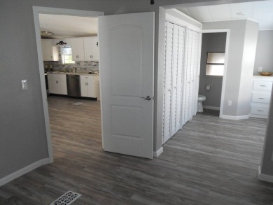 Charming two bedroom, one and a half bathroom home in the Bass on Polo Park East in Florida - for sale on GolfHomes.com, golf home, golf lot