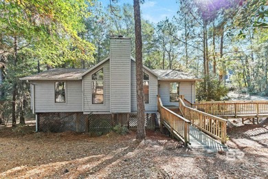 Looking for a home that feels like a cozy retreat tucked away in on Lake Forest Yacht and Country Club in Alabama - for sale on GolfHomes.com, golf home, golf lot