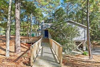 Looking for a home that feels like a cozy retreat tucked away in on Lake Forest Yacht and Country Club in Alabama - for sale on GolfHomes.com, golf home, golf lot