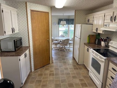 Discover this beautifully furnished 3-bedroom, 2-bathroom home on Crystal Lake Club in Florida - for sale on GolfHomes.com, golf home, golf lot