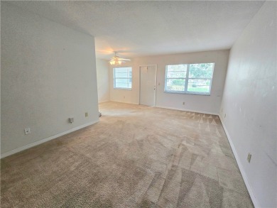 Your canvas awaits! Just needs a little TLC to make it shine on The American Golf Club in Florida - for sale on GolfHomes.com, golf home, golf lot