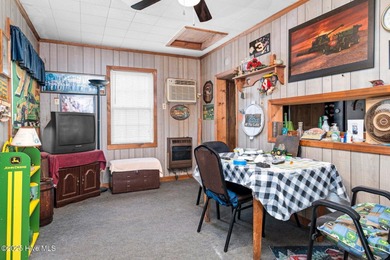 Escape to Lake Royale with this unique weekend retreat at 106 & on River Golf and Country Club at Lake Royale in North Carolina - for sale on GolfHomes.com, golf home, golf lot