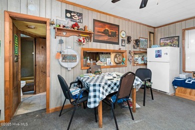 Escape to Lake Royale with this unique weekend retreat at 106 & on River Golf and Country Club at Lake Royale in North Carolina - for sale on GolfHomes.com, golf home, golf lot