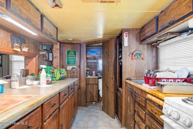 Escape to Lake Royale with this unique weekend retreat at 106 & on River Golf and Country Club at Lake Royale in North Carolina - for sale on GolfHomes.com, golf home, golf lot