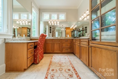 This Florida-style, hard stucco home is a beautiful ranch home on Trump National Golf Club Charlotte in North Carolina - for sale on GolfHomes.com, golf home, golf lot