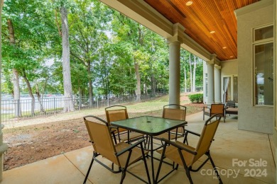 This Florida-style, hard stucco home is a beautiful ranch home on Trump National Golf Club Charlotte in North Carolina - for sale on GolfHomes.com, golf home, golf lot