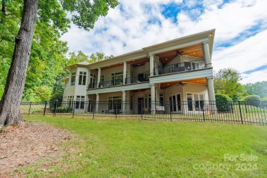 This Florida-style, hard stucco home is a beautiful ranch home on Trump National Golf Club Charlotte in North Carolina - for sale on GolfHomes.com, golf home, golf lot