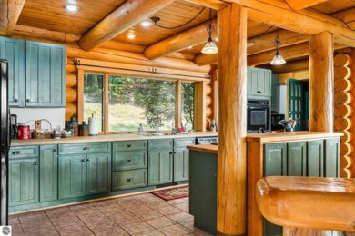 Welcome to this stunning Up North luxury log home perfectly on Boyne Mountain Resort - Monument Course in Michigan - for sale on GolfHomes.com, golf home, golf lot