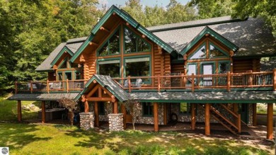 Welcome to this stunning Up North luxury log home perfectly on Boyne Mountain Resort - Monument Course in Michigan - for sale on GolfHomes.com, golf home, golf lot