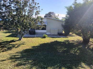 This 1988 offset double-wide home can fulfill your dreams of on Spanish Lakes Country Club in Florida - for sale on GolfHomes.com, golf home, golf lot