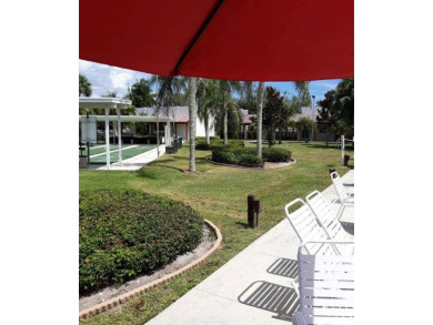 This 1988 offset double-wide home can fulfill your dreams of on Spanish Lakes Country Club in Florida - for sale on GolfHomes.com, golf home, golf lot