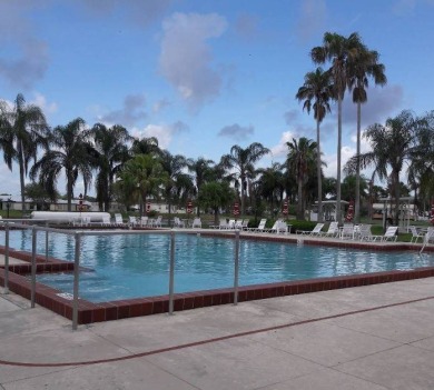 This 1988 offset double-wide home can fulfill your dreams of on Spanish Lakes Country Club in Florida - for sale on GolfHomes.com, golf home, golf lot