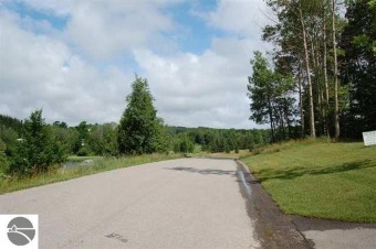 This beautiful building site is set on a hill overlooking the on A-Ga-Ming Golf Resort in Michigan - for sale on GolfHomes.com, golf home, golf lot