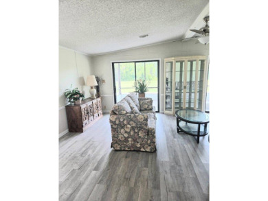 Welcome to your serene sanctuary nestled on an exterior lot of on Lake Henry Golf Club in Florida - for sale on GolfHomes.com, golf home, golf lot