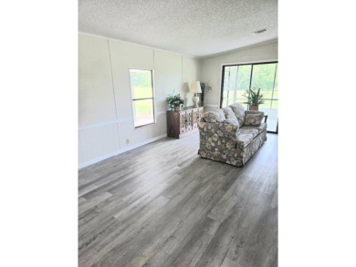 Welcome to your serene sanctuary nestled on an exterior lot of on Lake Henry Golf Club in Florida - for sale on GolfHomes.com, golf home, golf lot