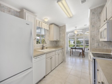 This 2004 2-bed, 2-bath split-plan home is nestled on a quiet on Barefoot Bay Golf Course in Florida - for sale on GolfHomes.com, golf home, golf lot