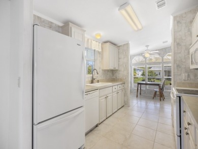 This 2004 2-bed, 2-bath split-plan home is nestled on a quiet on Barefoot Bay Golf Course in Florida - for sale on GolfHomes.com, golf home, golf lot