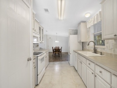This 2004 2-bed, 2-bath split-plan home is nestled on a quiet on Barefoot Bay Golf Course in Florida - for sale on GolfHomes.com, golf home, golf lot