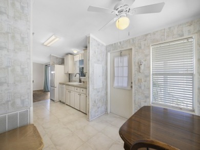 This 2004 2-bed, 2-bath split-plan home is nestled on a quiet on Barefoot Bay Golf Course in Florida - for sale on GolfHomes.com, golf home, golf lot