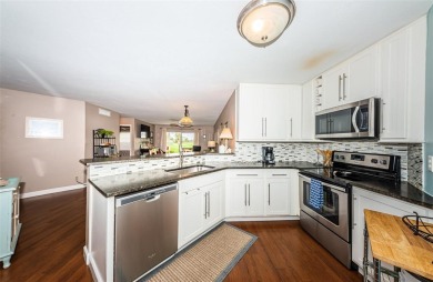 This ground-floor condo with 2 bedrooms and 2 bathrooms embodies on Isla Del Sol Yacht and Country Club in Florida - for sale on GolfHomes.com, golf home, golf lot