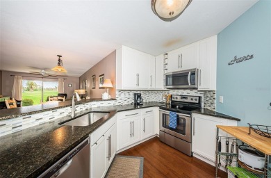 This ground-floor condo with 2 bedrooms and 2 bathrooms embodies on Isla Del Sol Yacht and Country Club in Florida - for sale on GolfHomes.com, golf home, golf lot