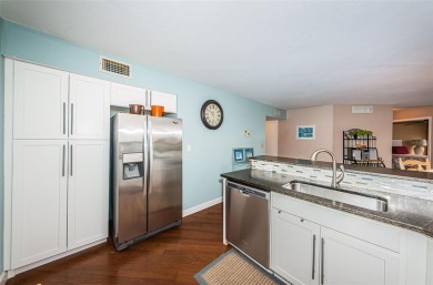 This ground-floor condo with 2 bedrooms and 2 bathrooms embodies on Isla Del Sol Yacht and Country Club in Florida - for sale on GolfHomes.com, golf home, golf lot