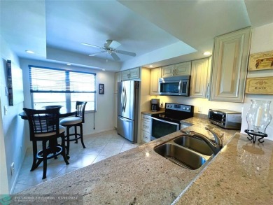 EXPANSIVE GOLF/WATER/CLUBHOUSE VIEW from this Favored LUXURY on Wynmoor Golf Course in Florida - for sale on GolfHomes.com, golf home, golf lot