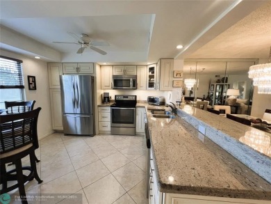 EXPANSIVE GOLF/WATER/CLUBHOUSE VIEW from this Favored LUXURY on Wynmoor Golf Course in Florida - for sale on GolfHomes.com, golf home, golf lot