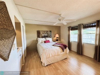 EXPANSIVE GOLF/WATER/CLUBHOUSE VIEW from this Favored LUXURY on Wynmoor Golf Course in Florida - for sale on GolfHomes.com, golf home, golf lot