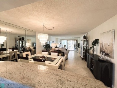 EXPANSIVE GOLF/WATER/CLUBHOUSE VIEW from this Favored LUXURY on Wynmoor Golf Course in Florida - for sale on GolfHomes.com, golf home, golf lot