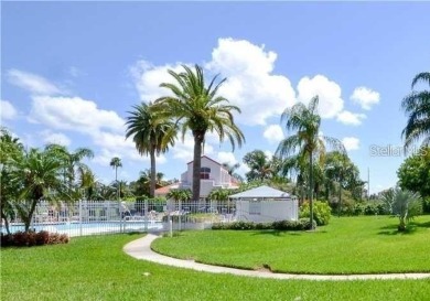 This ground-floor condo with 2 bedrooms and 2 bathrooms embodies on Isla Del Sol Yacht and Country Club in Florida - for sale on GolfHomes.com, golf home, golf lot