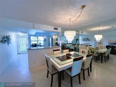 EXPANSIVE GOLF/WATER/CLUBHOUSE VIEW from this Favored LUXURY on Wynmoor Golf Course in Florida - for sale on GolfHomes.com, golf home, golf lot