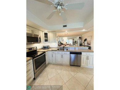 EXPANSIVE GOLF/WATER/CLUBHOUSE VIEW from this Favored LUXURY on Wynmoor Golf Course in Florida - for sale on GolfHomes.com, golf home, golf lot